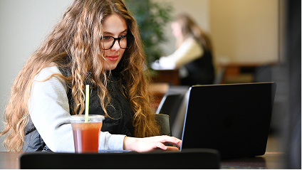 Student typing on computer